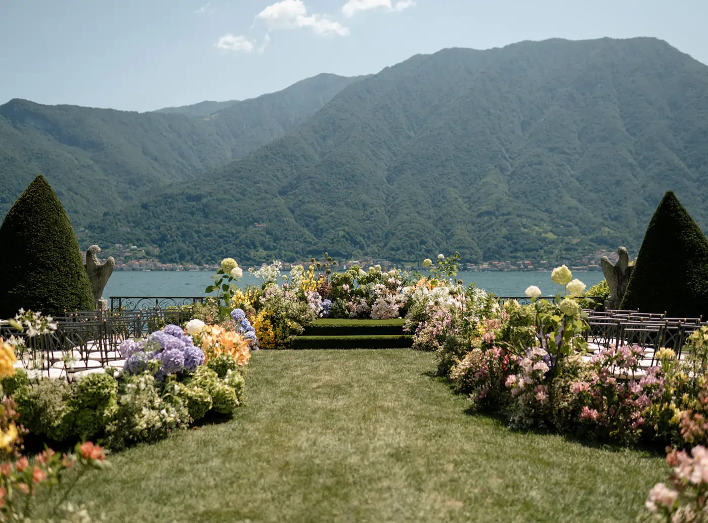 Outdoor Lakefront Wedding Ceremony Setup With Colorful Flowers