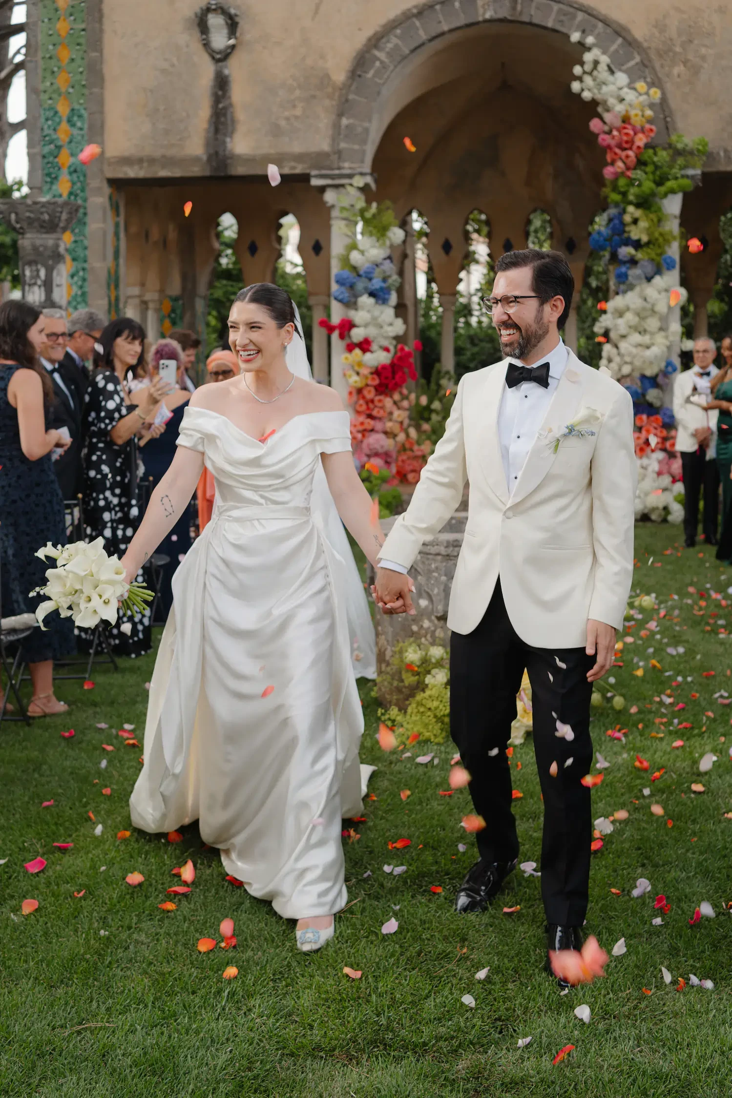 Bride and Groom Walking Through a Colorful Garden Wedding Ceremony at Villa Cimbrone