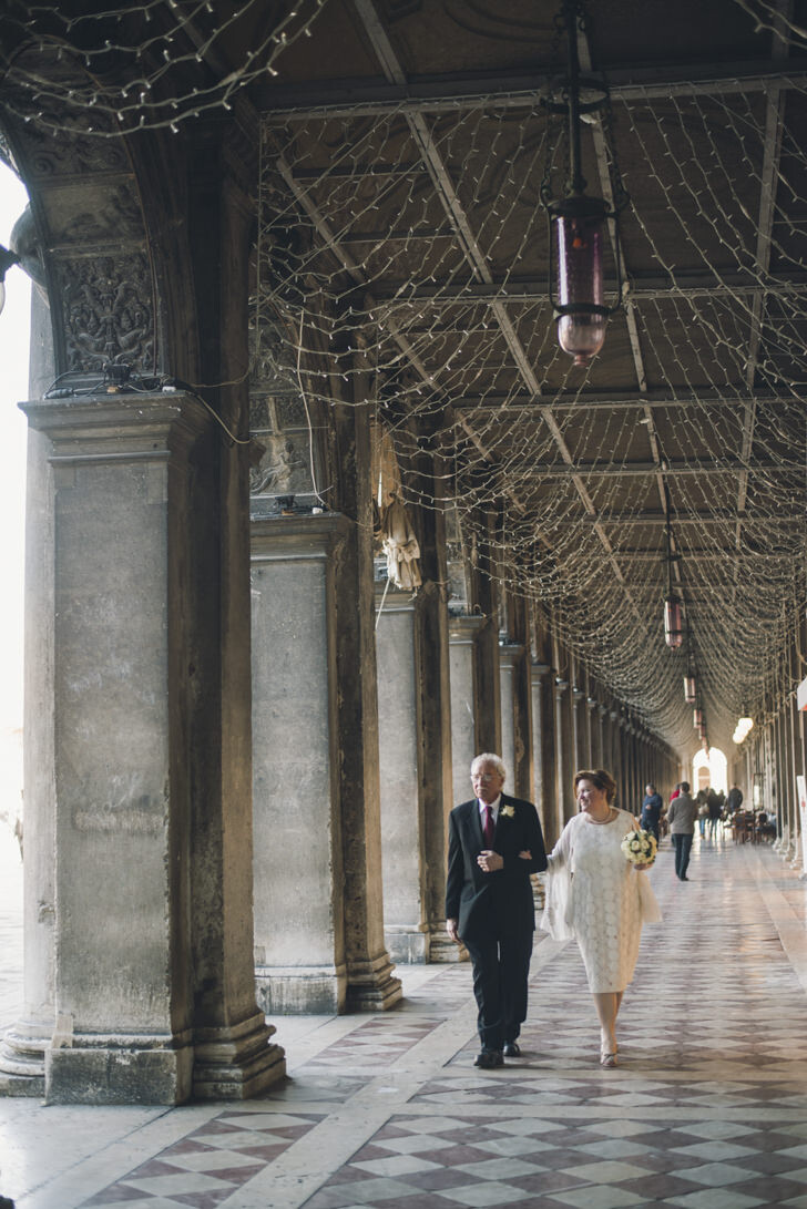 Bridal couple under St. Mark's Square arcades