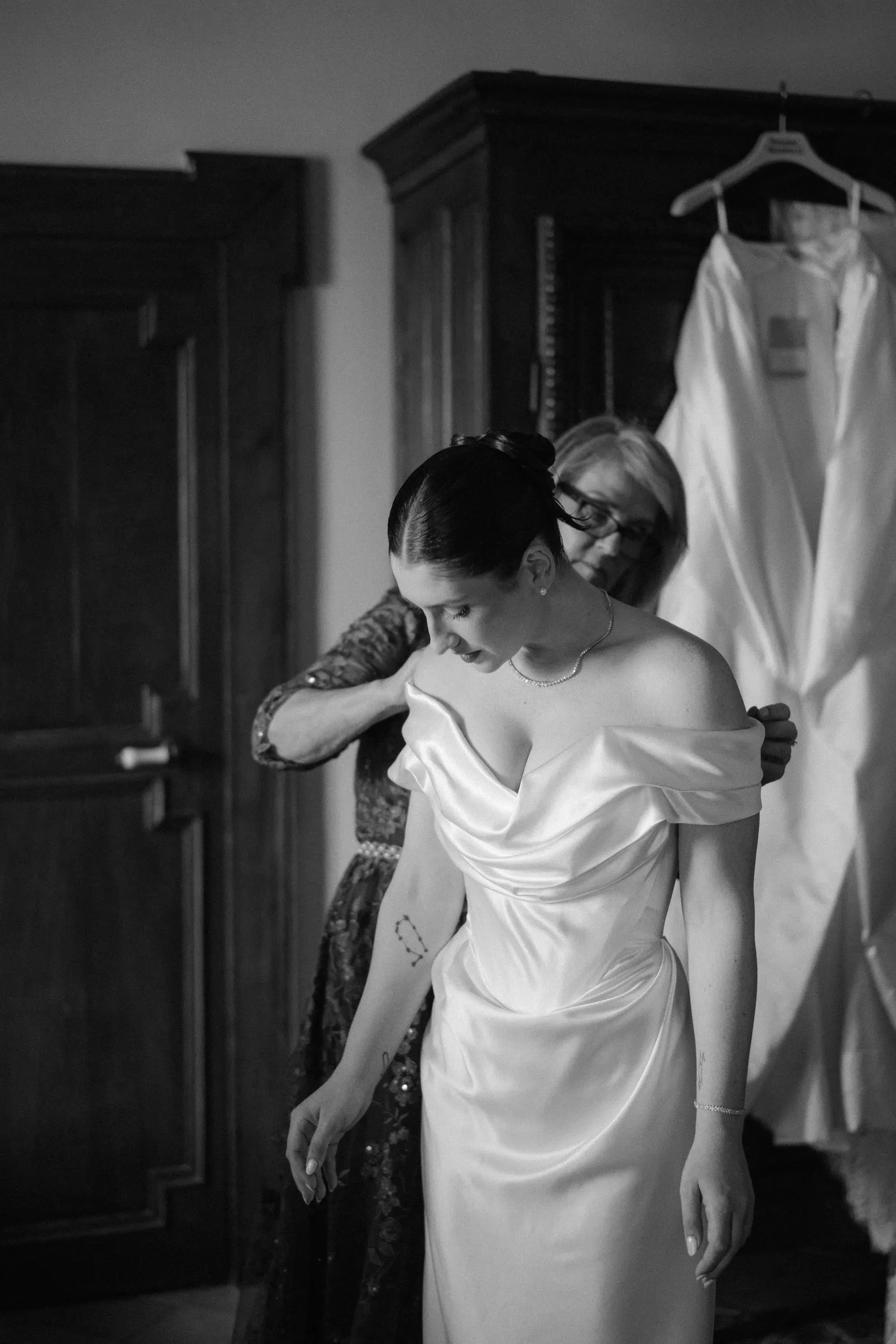 Black and white candid bride mother wedding prep