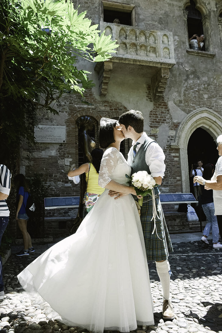 Newlyweds kissing in Verona