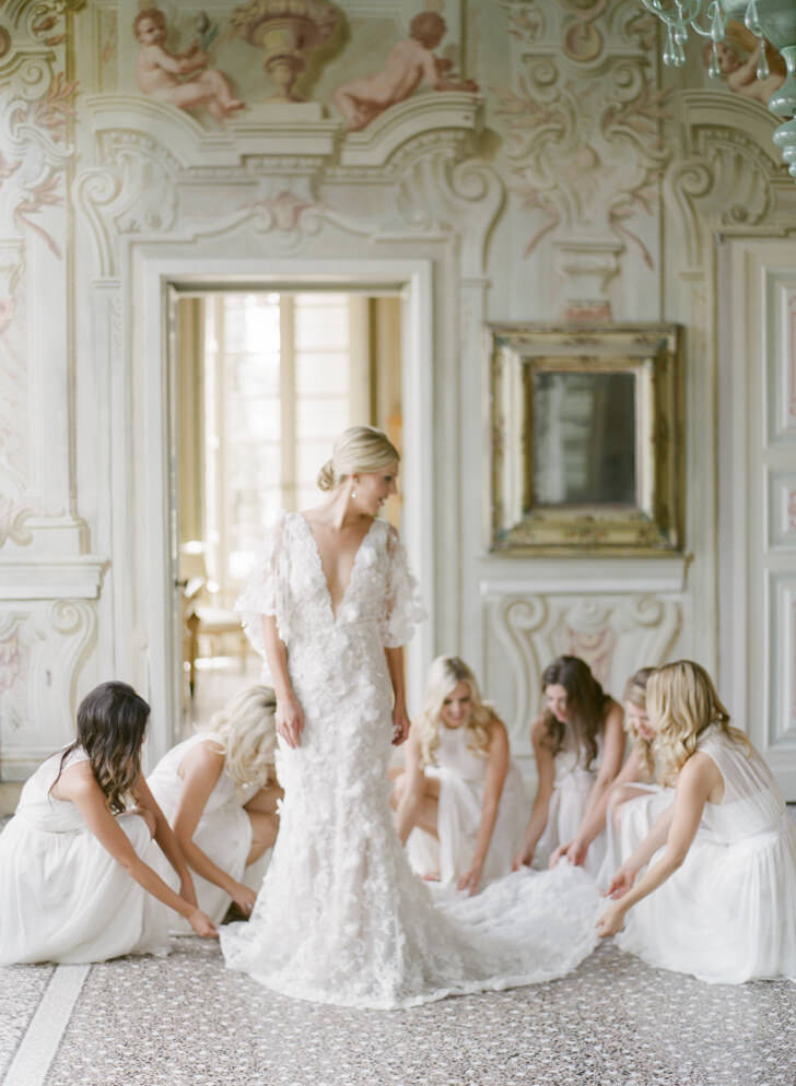 Bride and bridesmaids in the frescoed hall