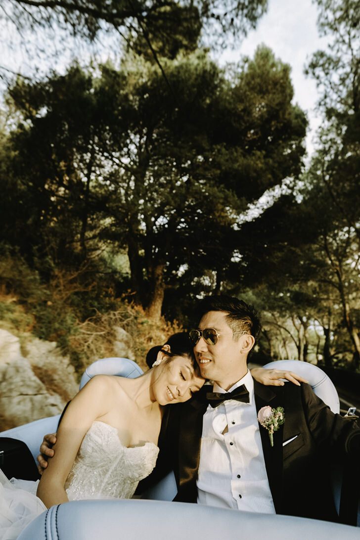 Bridal couple in a luxury car